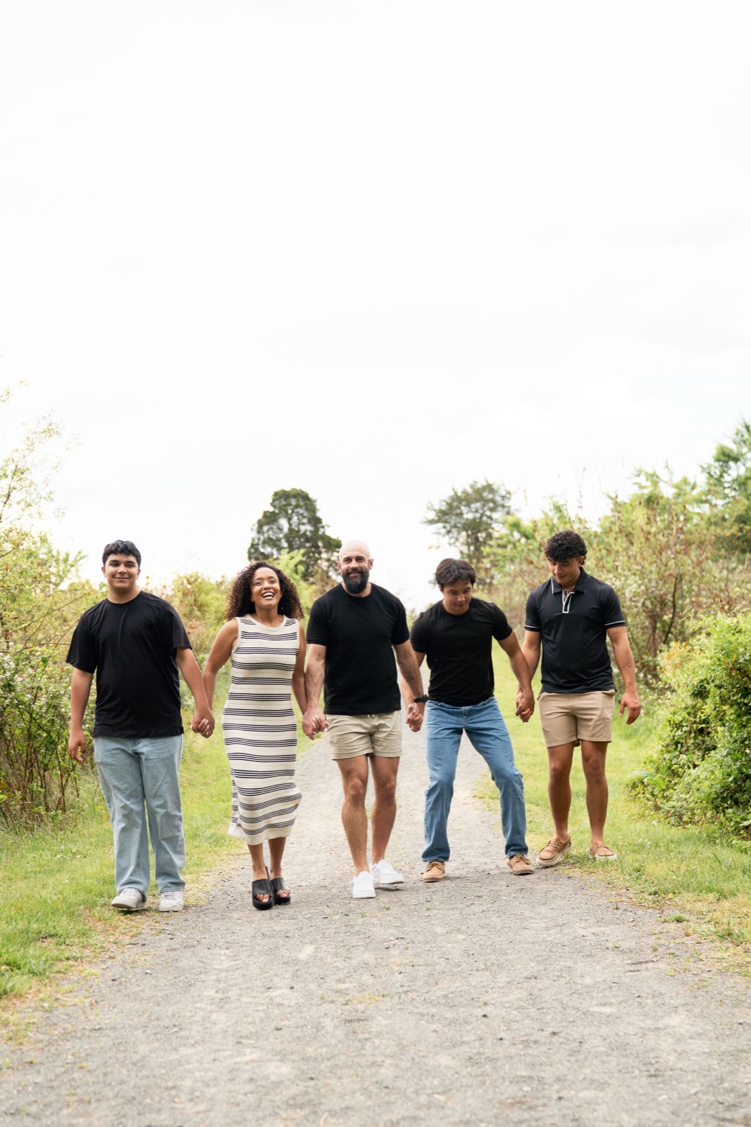 Erica, Joshua, and their three sons walking together