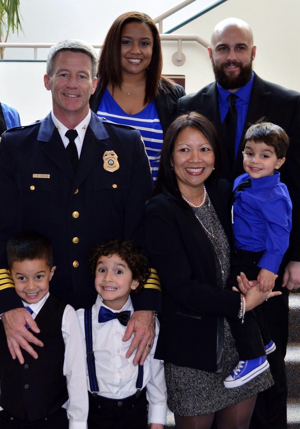 Erica with her family, including her father in his law-enforcement uniform