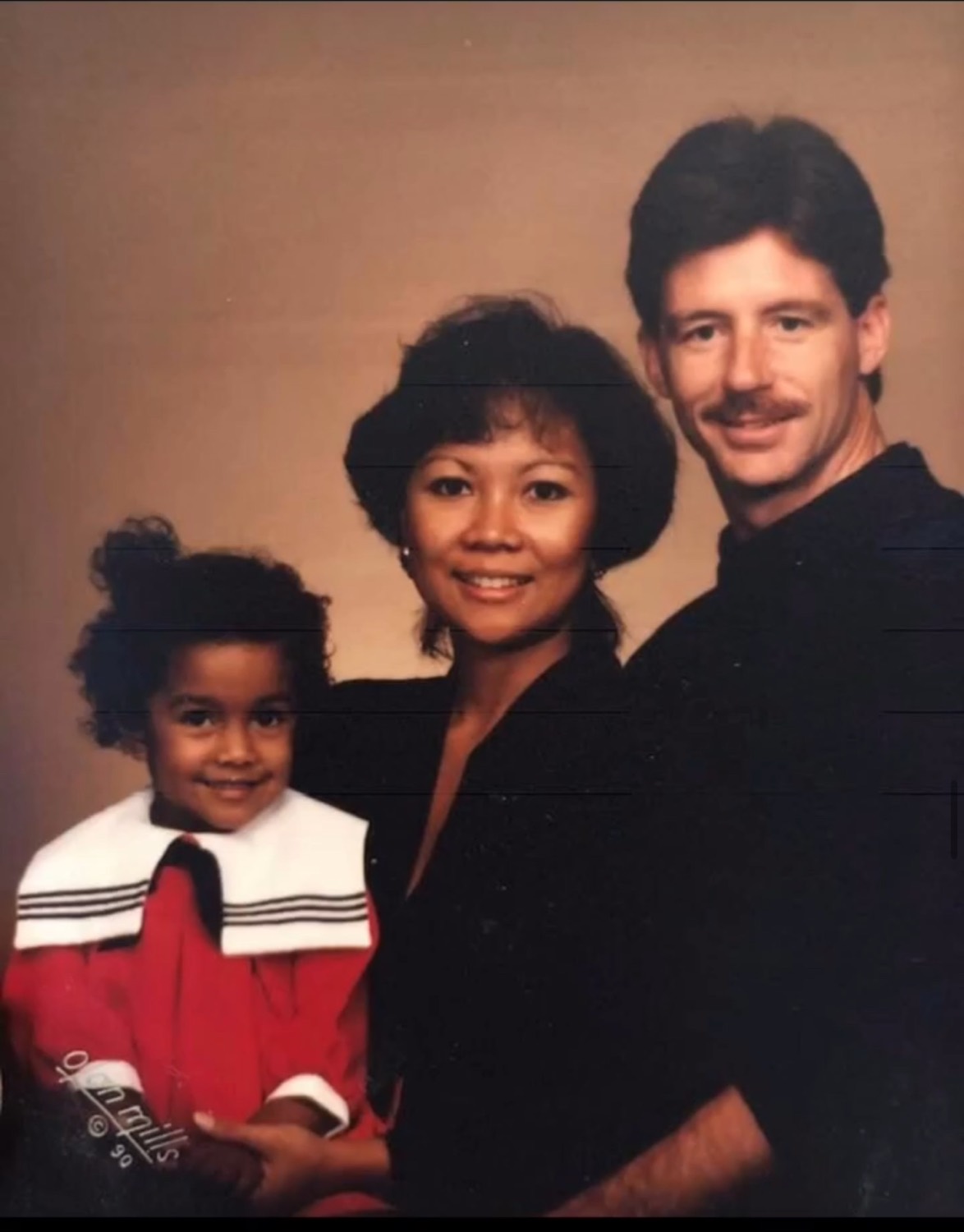 Young Erica with her mother and adoptive father